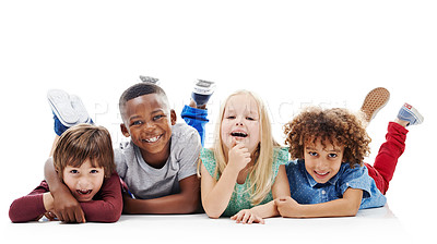 Buy stock photo Diversity, children and happy friends or fun on the floor together or against a white background and hug. Smile, kids and playful or laughing and isolated in studio or excited buddies and embrace