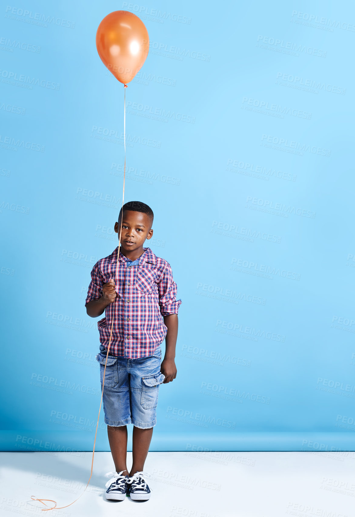 Buy stock photo Black child, portrait or balloon at wall mockup for party, birthday celebration or favorite color. Kid, floating toy or casual on blue background space for fun event with helium decoration in Nigeria