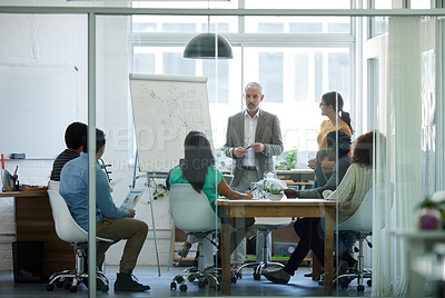 Buy stock photo Shot of a group of coworkers in a boardroom meeting