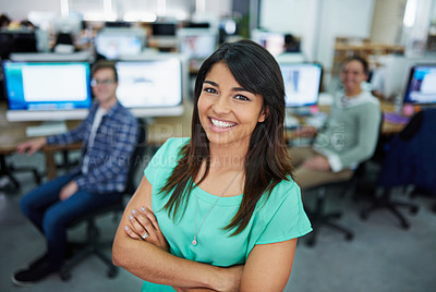 Buy stock photo Portrait of a young woman standing in an office with designers in the background