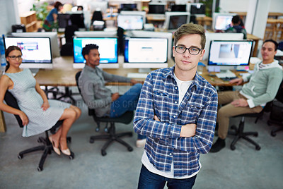 Buy stock photo Portrait of a young man standing in an office with designers in the background