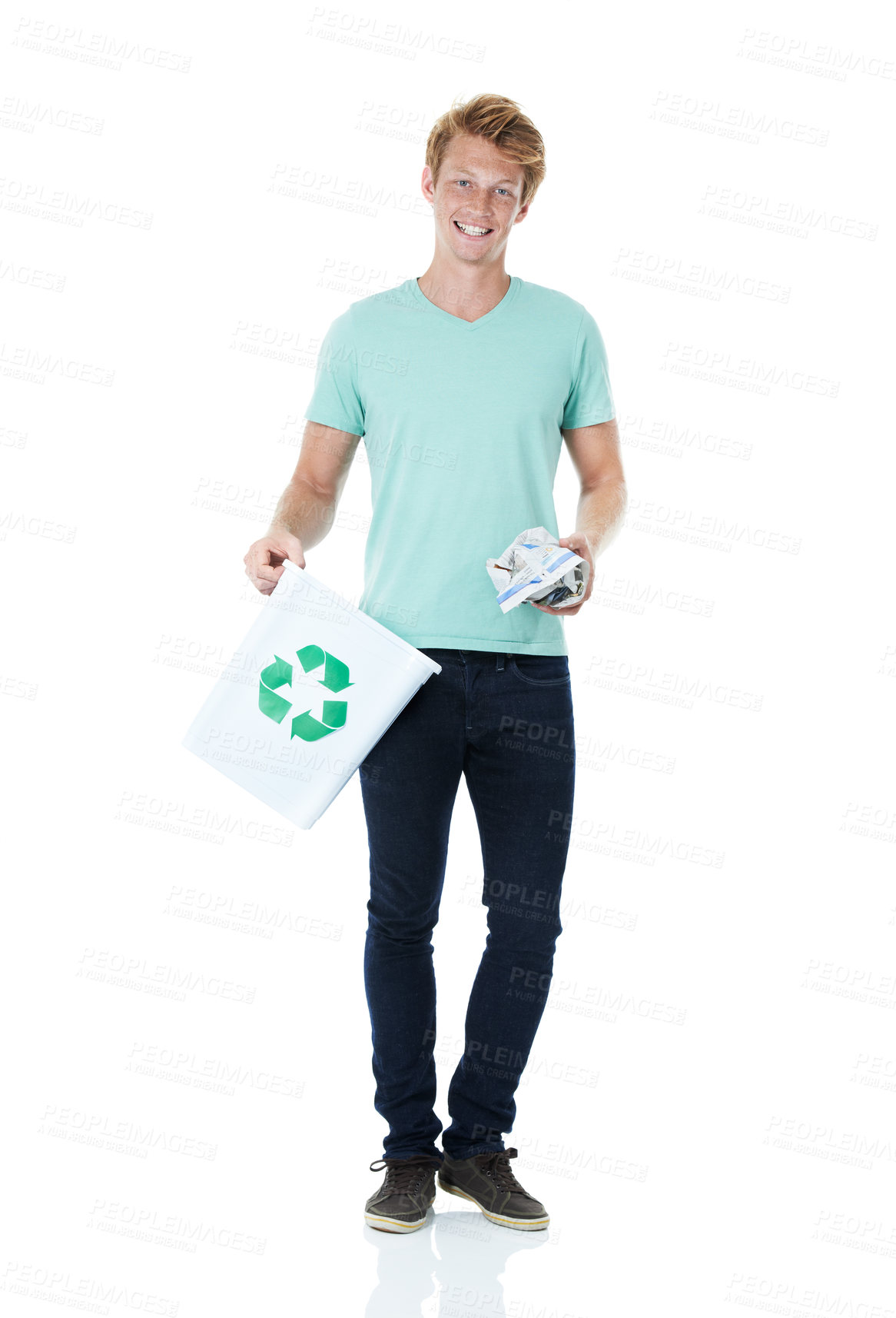 Buy stock photo A handsome young red-headed man ready to throw away a piece of paper in the recycling bin - portrait