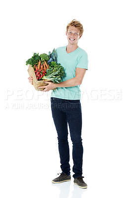 Buy stock photo Man, vegetables and basket in studio, happy and portrait with organic produce by white background. Person, shopping and container for groceries, nutrition and vegan diet with discount in Spain