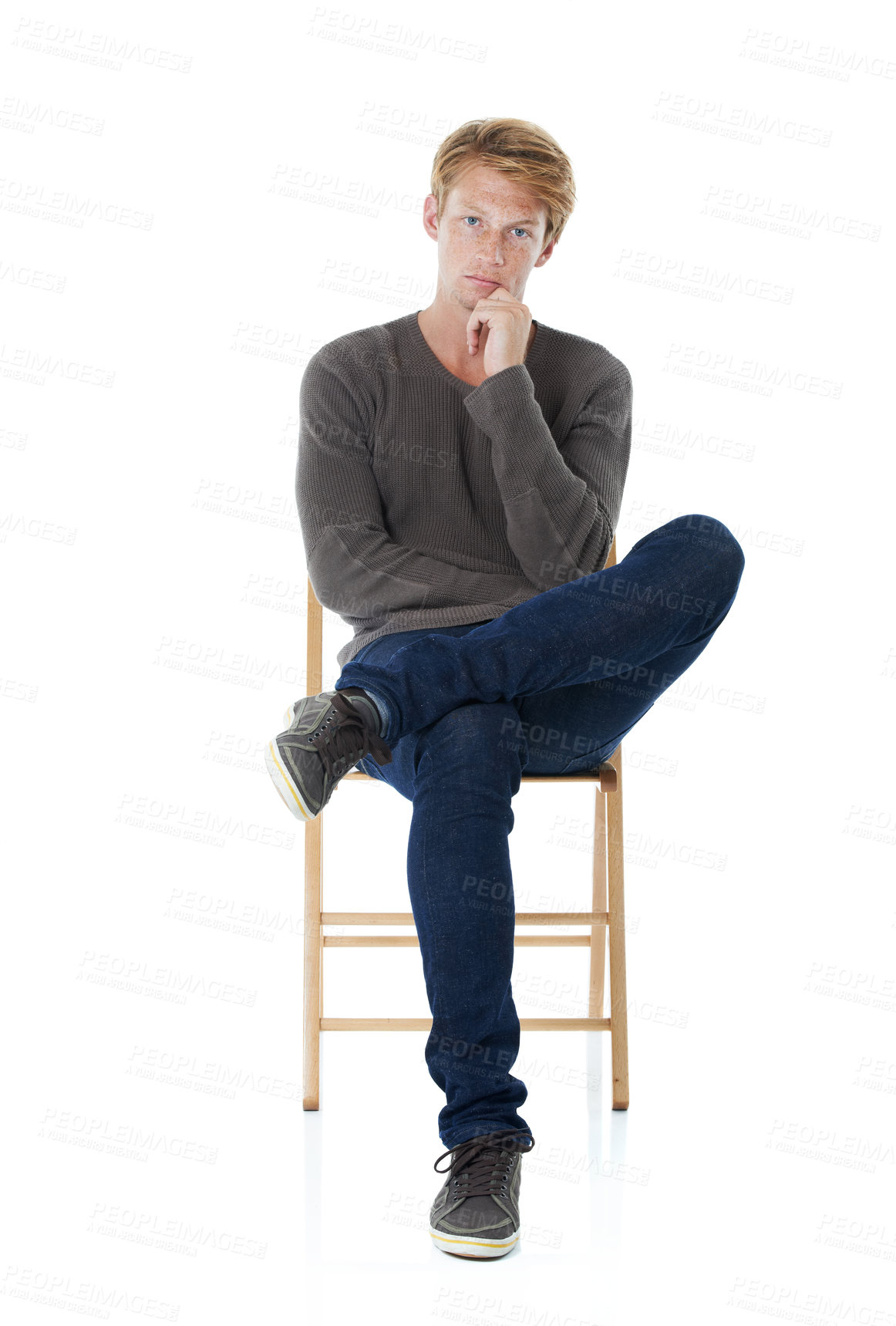 Buy stock photo Chair, thinking and portrait of man in studio with freckles, pride and confident attitude. Fashion, serious and isolated person in trendy sweater, style and casual clothes on white background