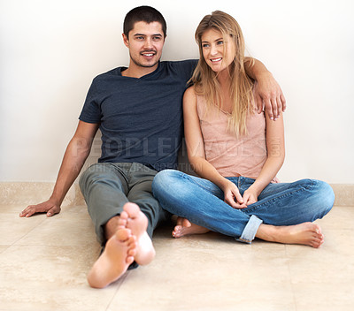 Buy stock photo Hug, relax and couple on the floor of their new house talking, bond and excited for real estate success. Property, moving and man and woman sitting on living room ground together in their dream home