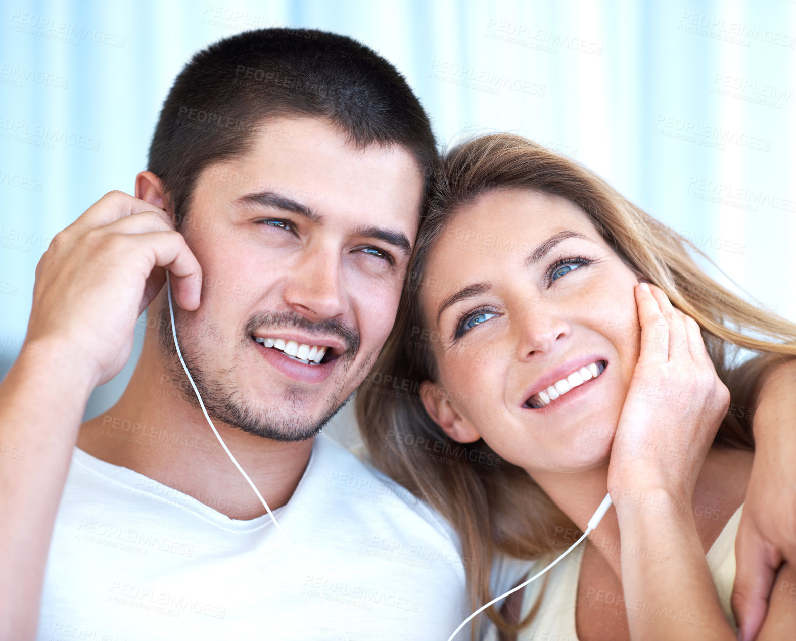 Buy stock photo Couple, love and earphones for music outdoor with bonding, radio app and listening to favorite song. People, audio playlist and embrace on date with smile, hugging and streaming service with relax