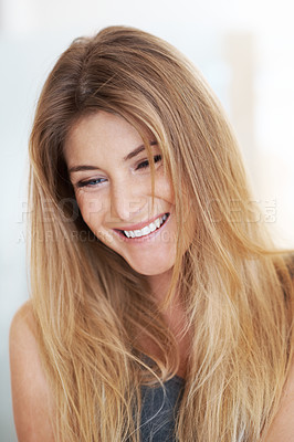 Buy stock photo A beautiful young woman laughing and looking down