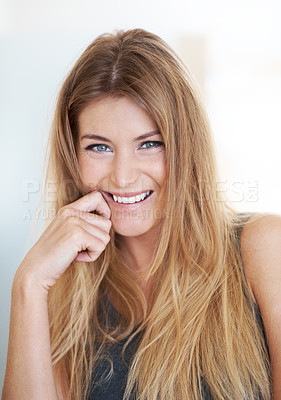 Buy stock photo A young woman smiling with her hand touching her chin