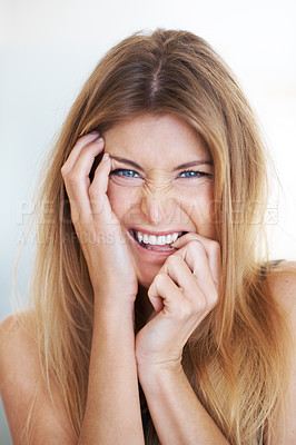 Buy stock photo A young woman laughing with her hands touching her face - closeup