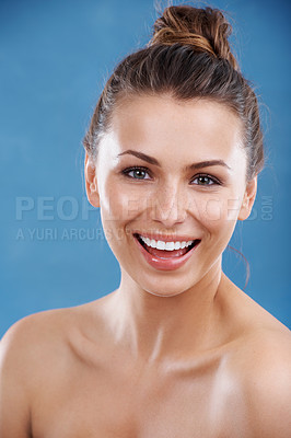 Buy stock photo Portrait of a beautiful young woman with perfect skin laughing against a blue background