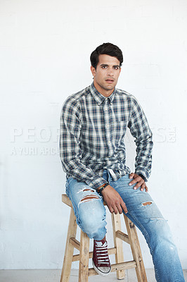 Buy stock photo Confidence, man and fashion in studio with on chair in casual wear, style and outfit on white background in Spain. Male person, isolated and portrait with street look, swag and comfortable with shirt