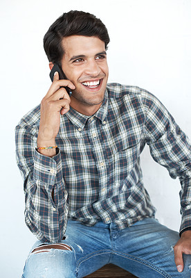 Buy stock photo Smile, phone call and creative man in studio on white background for communication, networking and chat. Designer, conversation and happy person speaking on smartphone for contact, discussion or talk