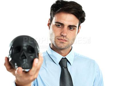 Buy stock photo Hand, black and skull by businessman in studio for death, symbol and failure against white background. Horror, fail and man showing human head for manipulation, emoji and bad luck while isolated