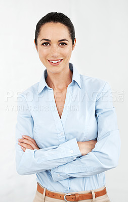 Buy stock photo Smiling businesswoman standing with her arms folded against a white background