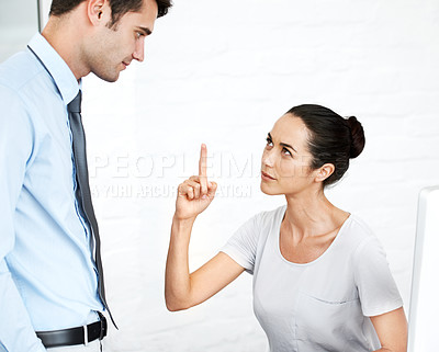 Buy stock photo Two young business colleagues having a disagreement at work