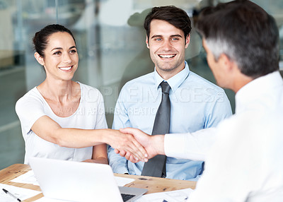 Buy stock photo Smiling businesspeople concluding a successful meeting together