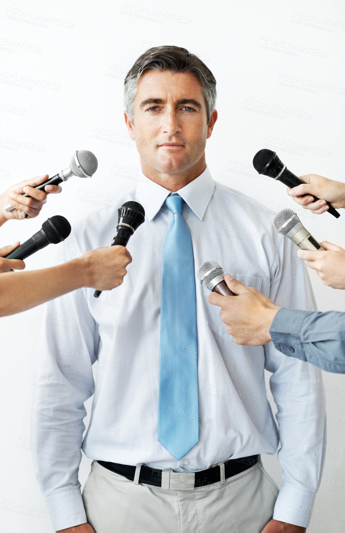 Buy stock photo Microphone, hands and portrait of businessman with interview in studio for press release. Confident, media and male law attorney with reporters for legal publicity for client by white background.