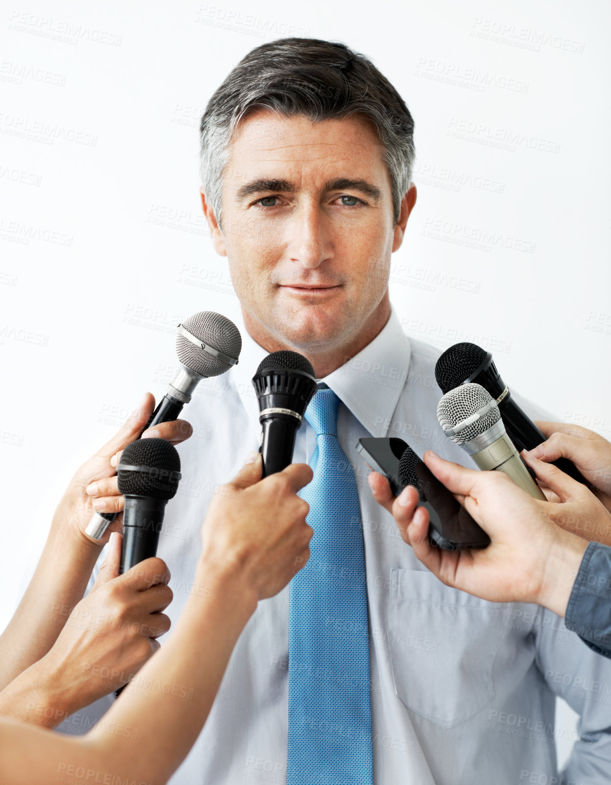 Buy stock photo Handsome mature businessman being interviewed against a white background