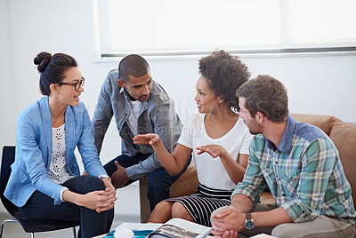 Buy stock photo Shot of a diverse group of designers having a meeting around a coffee table