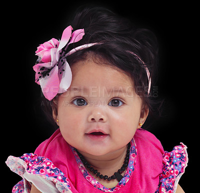 Buy stock photo Portrait, baby or girl with an innocent infant in studio on a black background in floral clothes. Kids, flower and development with a female child on dark space for cute or adorable product placement