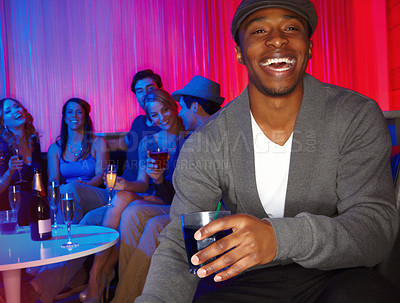 Buy stock photo A handsome young man out clubbing with his friends