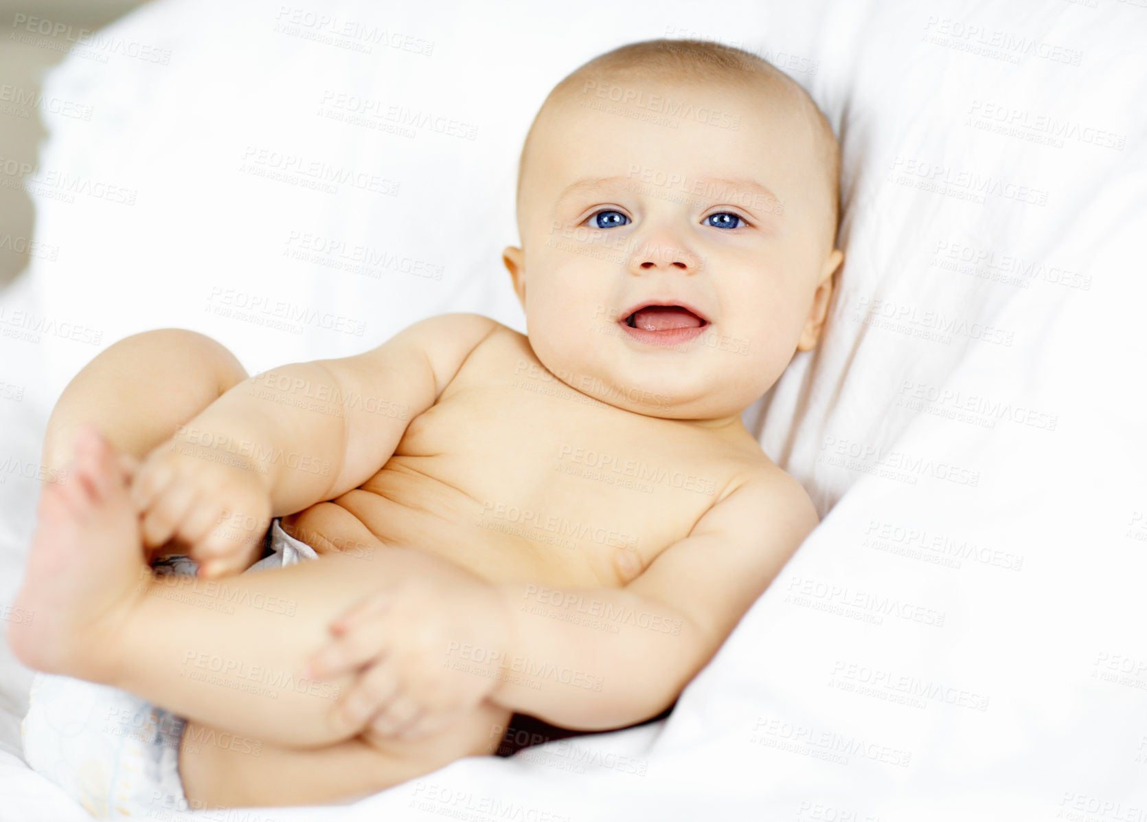 Buy stock photo Cute baby boy lying down and looking around with curiosity and wonder