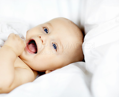 Buy stock photo Cute baby boy lying down and looking around with curiosity and wonder