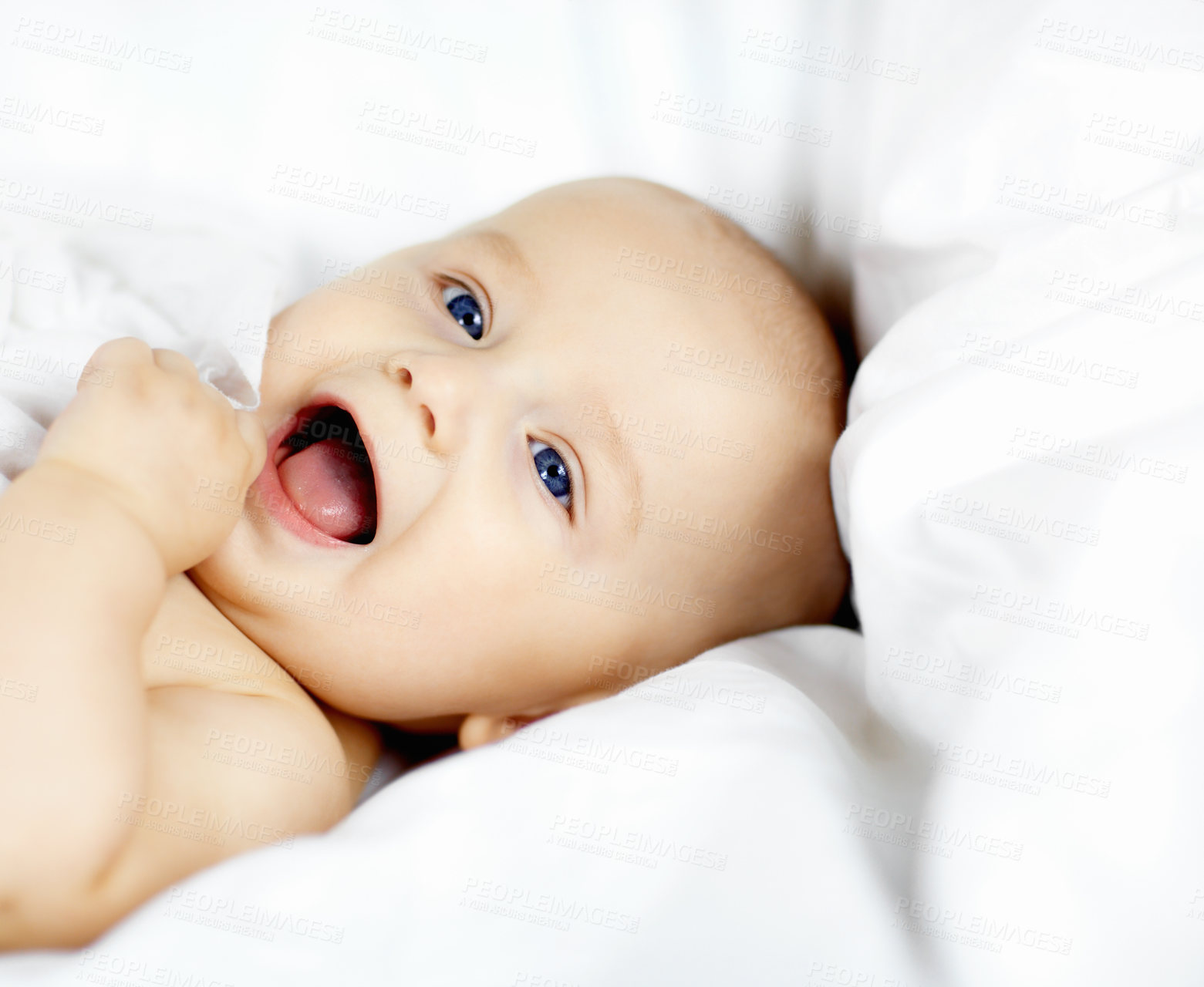 Buy stock photo Cute baby boy lying down and looking around with curiosity and wonder