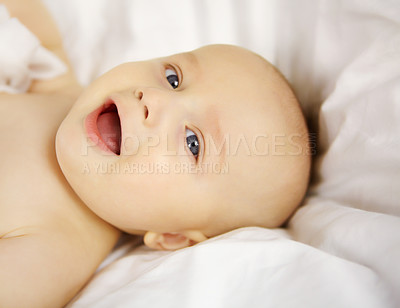 Buy stock photo Cute baby boy looking up at you with a sweet smile