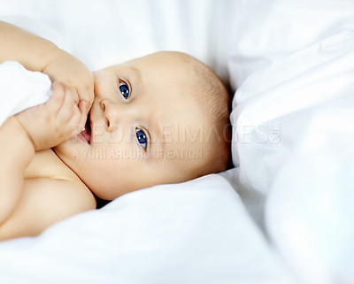 Buy stock photo Cute baby boy lying down and looking around with curiosity and wonder