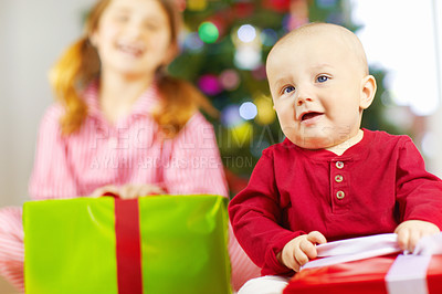 Buy stock photo Christmas, boy and baby with gift for celebration, festive season or happy. Children, male child or sister enjoy presents, happiness and vacation for Xmas, break and excited for holiday, relax or joy