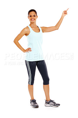 Buy stock photo Full-length portrait of an attractive young woman pointing towards copyspace