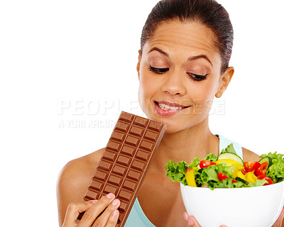Buy stock photo A beautiful young woman choosing between a healthy salad an a chocolate slab