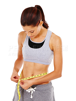 Buy stock photo A beautiful young woman measuring her waist