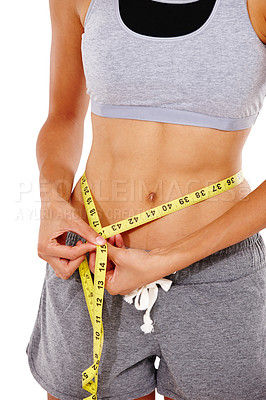 Buy stock photo Cropped image of a woman measuring her waist