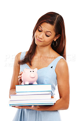Buy stock photo Young woman holding some textbooks and a piggybank against a white background