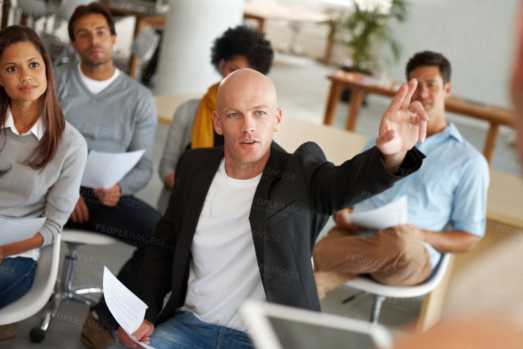 Buy stock photo A group of colleagues sitting in a business meeting