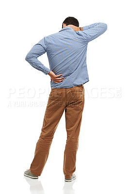 Buy stock photo Rearview of a young man holding his neck and back in pain