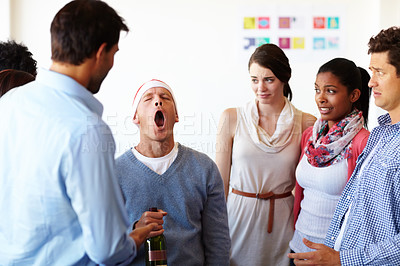 Buy stock photo Business people, drunk and man yawning and tired at Christmas office party with employees staring at behavior of worker at workplace. Men and women together while worried about alcohol wine problem