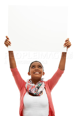 Buy stock photo Pretty young woman sitting down and holding up a poster of white copyspace