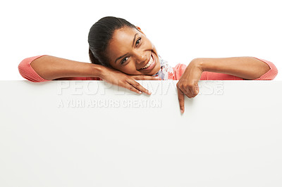 Buy stock photo Portrait of an attractive young woman standing behind and pointing at copyspace