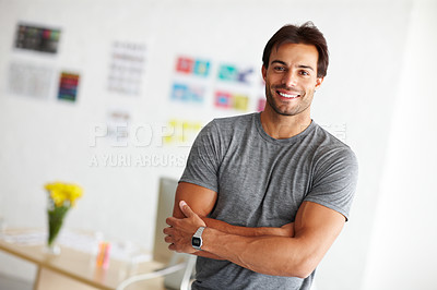 Buy stock photo Portrait of a smiling handsome man standing in his office with arms crossed
