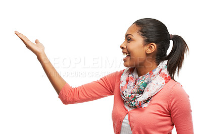 Buy stock photo A beautiful young woman pointing at your product against a white background