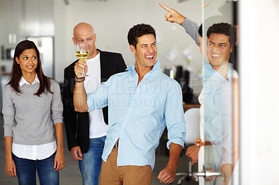 Buy stock photo A drunk man with a glass of wine in his hand at an office social