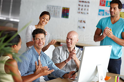 Buy stock photo A group of young colleagues celebrating in the office