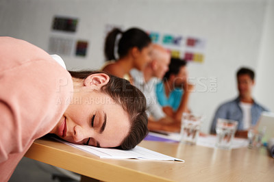 Buy stock photo Closeup shot of a young intern asleep with her head on a boardroom table during a meeting