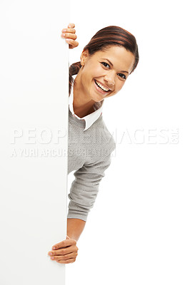 Buy stock photo Studio portrait of an attractive young woman looking out from behind copyspace isolated on white