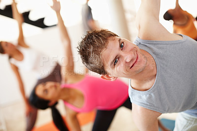 Buy stock photo Portrait, smile and stretching, man in yoga class for fitness, commitment and body wellness. Pilates, men and women in gym together for holistic health, mindfulness and happy person at exercise club.