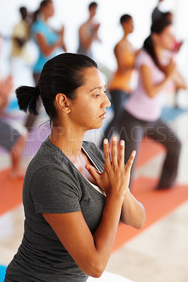 Buy stock photo Woman, fitness and meditation with namaste for yoga class, exercise or workout together at dojo. Young, female person or yogi with mat, team or group for awareness, inner peace or balance at studio