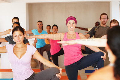 Buy stock photo Yoga class, stretching knee and people with coach at gym, exercise and healthy body or wellness. Fitness, happy group and instructor practice flexibility, balance legs and pilates in club together